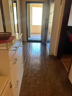 a kitchen with a tile floor and a hallway at Apartmani VV in Cetinje