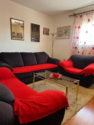 a living room with two couches and a table at Apartmani VV in Cetinje