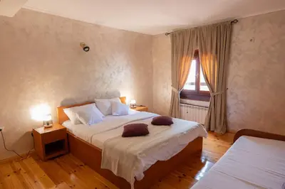 a bedroom with a large bed and a window at Villa Brda in Petrovac na Moru