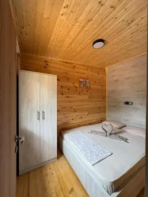 a bedroom with a bed with a wooden ceiling at Kućica Ušće - Ada Bojana in Ulcinj