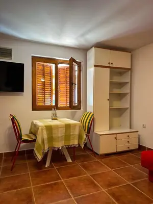 a dining room with a table and a window at Cozy Place in Utjeha