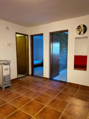 a room with glass doors and a tiled floor at Cozy Place in Utjeha