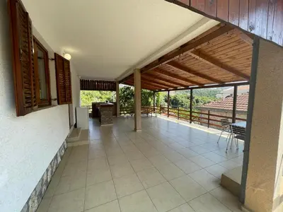 an open porch of a house with a patio at Cozy Place in Utjeha