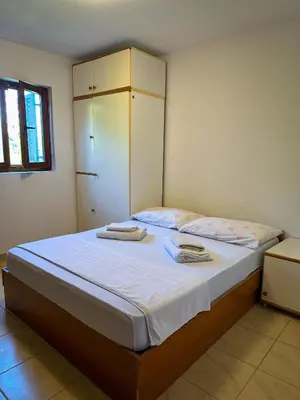 a bedroom with a bed with two towels on it at Cozy Place in Utjeha