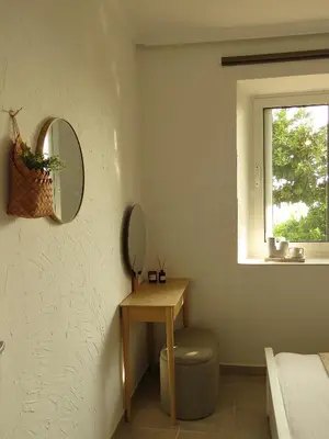 a bedroom with a mirror and a table and a window at Seas the day - Apartment with sea view and terrace in Ulcinj