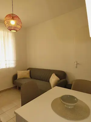a living room with a couch and a table at Seas the day - Apartment with sea view and terrace in Ulcinj