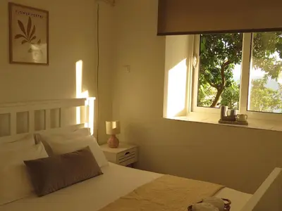 a bedroom with a white bed and a window at Seas the day - Apartment with sea view and terrace in Ulcinj