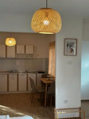a kitchen and dining room with a table and a chandelier at Seas the day - Apartment with sea view and terrace in Ulcinj