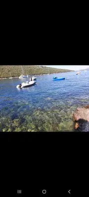 two boats in a large body of water at Apartman u zelenilu Bigove in Kotor