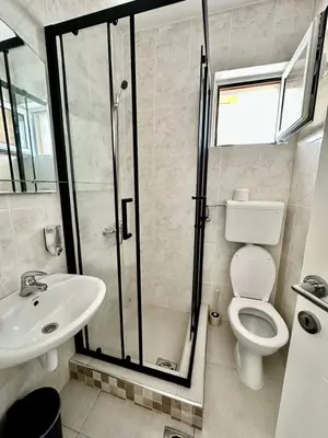 a bathroom with a shower and a toilet and a sink at Villa IL Mare in Budva