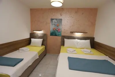 two beds in a small room with at Villa IL Mare in Budva