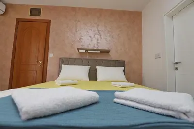 a bed with two white pillows on top of it at Villa IL Mare in Budva