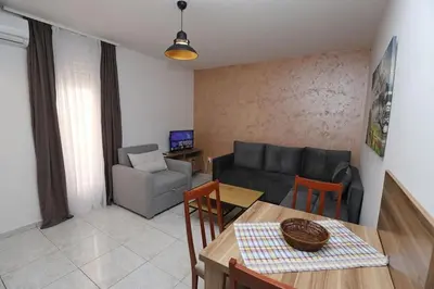 a living room with a couch and a table and chairs at Villa IL Mare in Budva