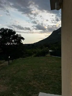 a view of a field of grass with a mountain at Oak valley in Bar