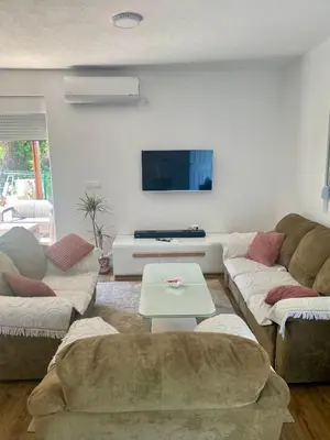 a living room with two couches and a tv at Oak valley in Bar