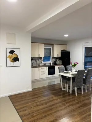 a kitchen and dining room with a table and chairs at Oak valley in Bar
