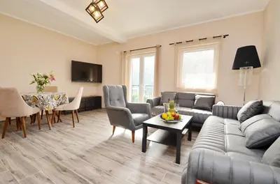 a living room with a couch and a table at Apartments Orizzonte with beautiful view of the bay in Kotor
