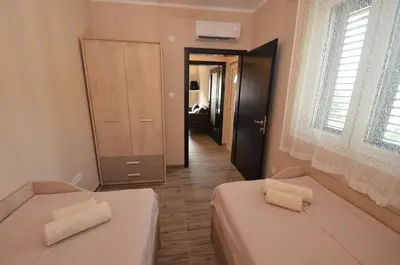 a room with two beds and a hallway at Apartments Orizzonte with beautiful view of the bay in Kotor