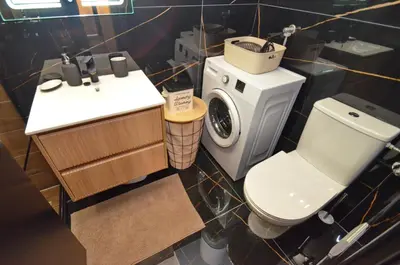 a bathroom with a toilet and a sink and a washing machine at Apartments Orizzonte with beautiful view of the bay in Kotor