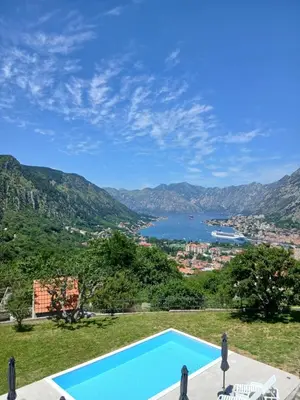 a swimming pool with a view of the water at Apartments Orizzonte with beautiful view of the bay in Kotor