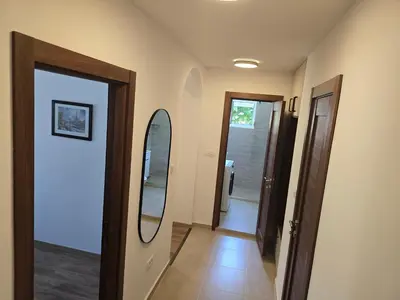 a hallway with two mirrors on the wall at Apartman Cetinje in Cetinje