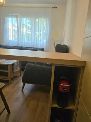 a room with a desk and a chair and a couch at Apartman Cetinje in Cetinje