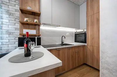 a bottle of wine sitting on a counter in a kitchen at Hillside Apartments in Becici