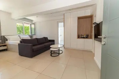 a living room with a couch and a table at Horizont studio in Becici