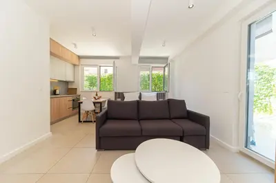 a living room with a couch and a table at Horizont studio in Becici