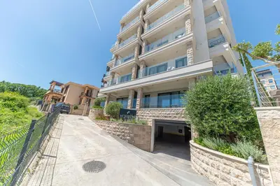 an apartment building with a walkway in front of it at Horizont studio in Becici