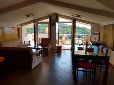 a living room with a couch and a table at Apartmani Neda Bane in Petrovac na Moru