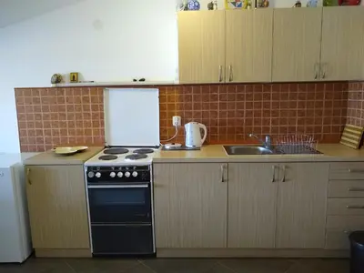 a kitchen with a stove and a sink at Apartmani Neda Bane in Petrovac na Moru