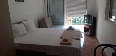 a bedroom with a bed with a towel on it at Apartmani Neda Bane in Petrovac na Moru