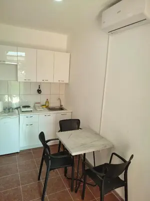 a kitchen with a table and chairs in a room at Blazo apartments in Ulcinj