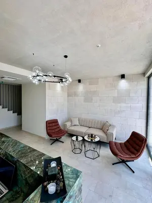 a living room with a couch and two chairs at Residenza Apartments in Kotor