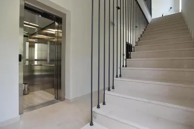 a staircase in a building with a glass door at Residenza Apartments in Kotor