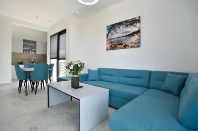 a living room with a blue couch and a table at Residenza Apartments in Kotor