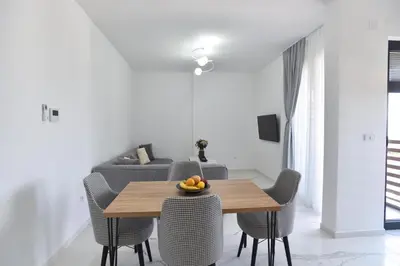 a dining room with a wooden table and chairs at Residenza Apartments in Kotor