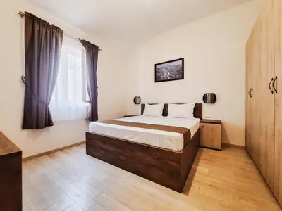 a bedroom with a bed and a large window at Casa Oliva Villa with private heating pools in Budva