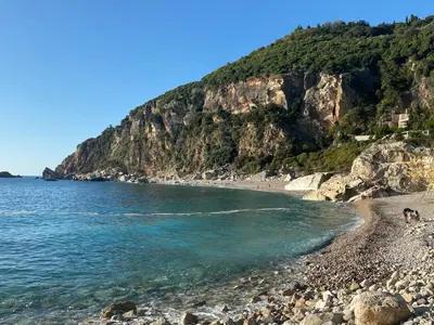 a beach with a rocky shore and the ocean at Casa Oliva Villa with private heating pools in Budva