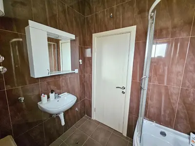 a bathroom with a sink and a mirror and a shower at Guesthouse Lole in Bar
