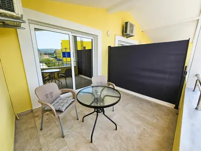 a room with a table and chairs and a blackboard at Guesthouse Lole in Bar