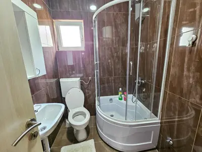 a bathroom with a shower and a toilet and a sink at Guesthouse Lole in Bar
