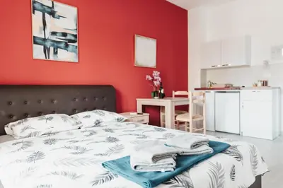 a bedroom with a bed with a red wall at Guesthouse Lole in Bar