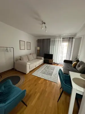 a living room with a couch and a tv at Apartment Studio in Budva