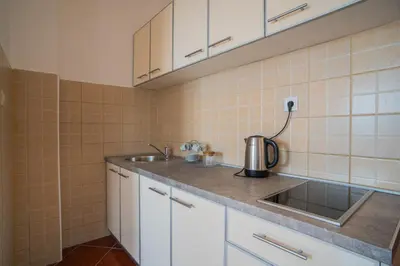 a kitchen with a sink and a counter top at Suite Apartment Sveti Stefan in Sveti Stefan