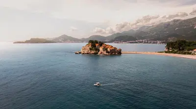a small island in the middle of a body of water at Suite Apartment Sveti Stefan in Sveti Stefan