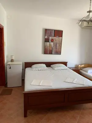 a bedroom with a bed and a picture on the wall at Apartments Boffi in Ulcinj