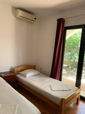 a bedroom with two beds and a window at Apartments Boffi in Ulcinj