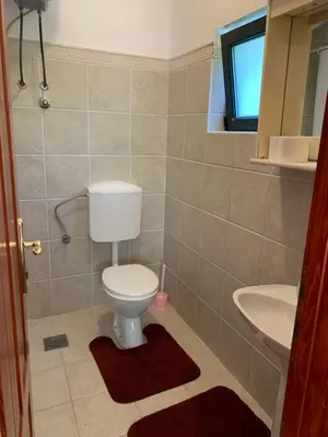 a bathroom with a toilet and a sink at Apartments Boffi in Ulcinj